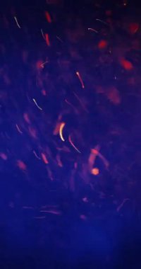 Büyüleyici turuncu ve mavi bokeh parçacıkları hızla dönerek dinamik ve büyüleyici bir görsel ekran oluşturuyorlar.