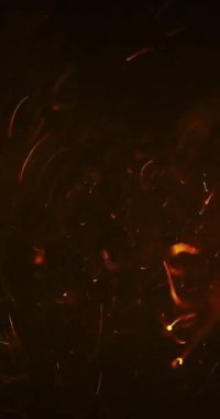 Titrek sarı-turuncu atomlar dinamik bir şekilde karanlık bir zemin üzerinde dönerek enerji ve hareketi yakalar.