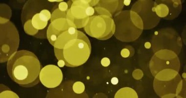 Sarı dairesel parçacıklar karanlıkta hareket ediyor. Karmaşık hareket ve ayrıntıları gösteriyor.