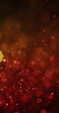 Rüya gibi bokeh 'in ortasında hareketli parlak sarı ve turuncu parçacıkların büyüleyici bir karışımı, huzurlu ve büyüleyici bir görsel ortam yaratıyor.
