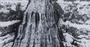 Dynjandi Şelalesi 'nin güçlü akıntısına yaklaşan İHA görüntüleri bu görkemli çağlayanın güçlü akışını ve dinamik enerjisini vurguluyor.
