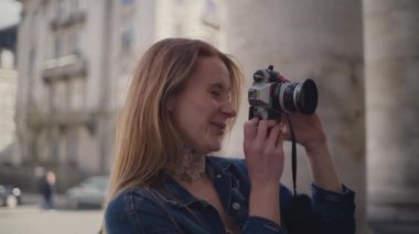 Kot ceket giyen bir turist, Frederik Kilisesi 'nin önünde fotoğrafçılığa daldıklarında coşkuyla gülümsüyor.
