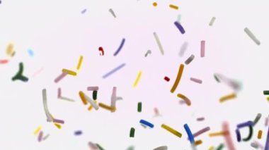 Parlak renkli serpintiler yavaş çekimde temiz beyaz bir arkaplan üzerinde zarif bir şekilde uçar, neşeli ve neşeli bir atmosfer yaratır.