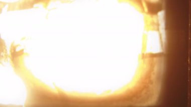 8mm 'lik bir film şeridi, film ortamının nostaljik arkaplanına karşı parlak, ateşli bir alevle çarpıcı bir şekilde tutuştu.