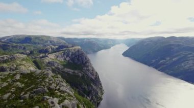 Sakin bir Norveç nehrinin engebeli dağlardan zarif bir şekilde akışını gösteren bir hava manzarası
