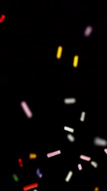 Koyu bir arkaplan üzerinde yukarı doğru yüzen renkli jimmler, oyuncu ve dinamik bir hareket yaratıyor