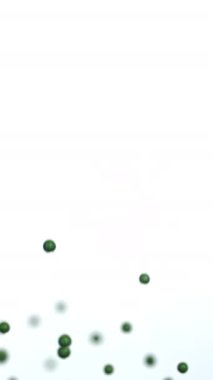 Yeşil şeker beyaz bir zemin üzerinde nazikçe yüzer, yumuşak ve eğlenceli bir hareket yaratır