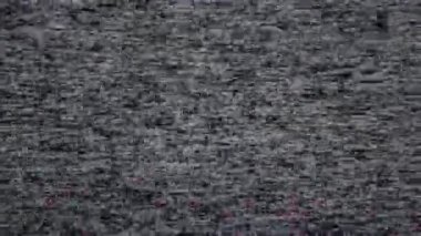 Sabit ve kar efektlerini gösteren eski bir VHS teyp kaydı, eski televizyon ekranlarının bulanık dokusunu ve parazitini yakalıyor