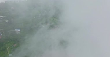 İnsansız hava aracı Narchyang Köyü üzerinde süzülüyor, canlı tarım alanları ve yuvarlanan tepeler sergiliyor, kırsal Nepal 'in sakin güzelliğini yukarıdan yakalıyor.