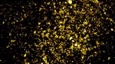 Altın konfeti parçacıkları yavaş çekimde havada yavaşça sürüklenerek şenlikli ve zarif bir atmosfer yaratıyor.