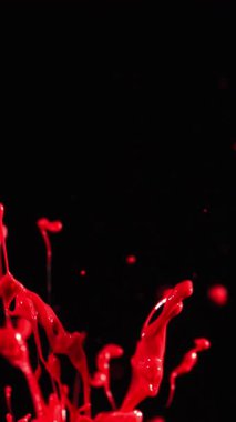 Çarpıcı ve dinamik bir görsel efekt yaratan, koyu bir arka planda patlayan kırmızı renkli dramatik bir yavaş çekim patlaması.