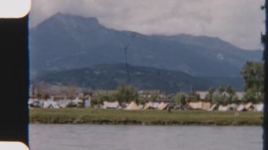8mm 'lik vintage görüntüler Garda Gölü' nün çadırlarla dolu ve nefes kesici dağ manzaralarıyla çevrili hareketli bir kamp alanını çekiyor.