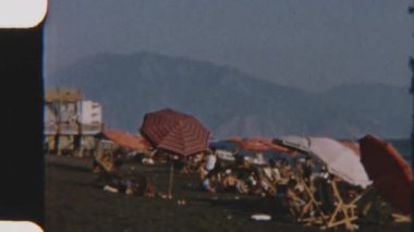 Huzurlu bir plajda, sakin bir atmosferin tadını çıkarırken, okyanus dalgaları kıyıya vuruyor.