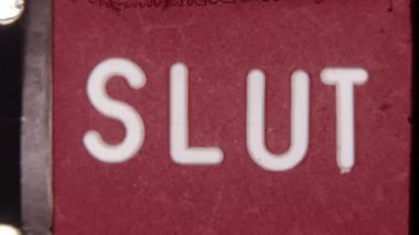 Old 8mm film ending featuring the word Slut in white text on a bold red backdrop, capturing a vintage, retro aesthetic