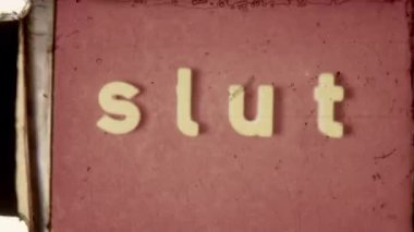 8mm vintage footage featuring the word Slut in small caps as the end title on a vibrant red background, showcasing a retro film aesthetic with a grainy texture