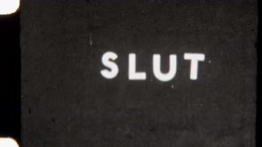 Grainy 8mm footage featuring the Slut end title in bold white text on a solid black background, offering a classic vintage film style