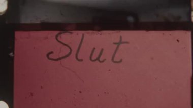 Handwritten back-to-back end titles on a red backdrop, featuring KE Movie Pictures transforming into Slut with a turning effect