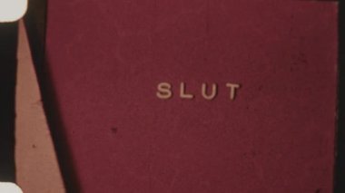 Film ending featuring a glitching Slut title on a vibrant red backdrop, creating a retro, digital distortion effect