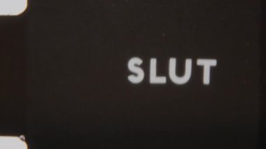 A glitchy Slut end title flickering on a black background, creating a retro, digital distortion effect
