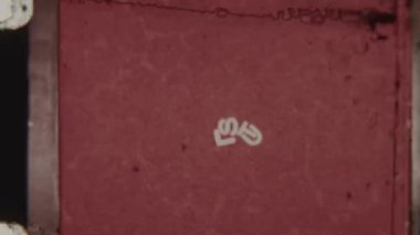 Vintage 8mm film clip showcasing the word SLUT in bold white letters against a vibrant red background, with an authentic retro aesthetic