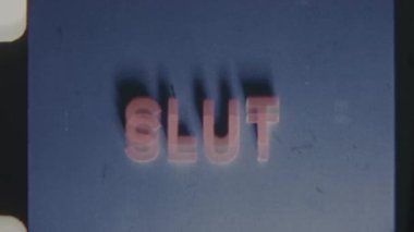 Vintage 8mm film footage featuring the word Slut in bold white text on a blue background that gradually fades to pink
