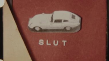 Retro 8mm film showing the word Slut with a car illustration on a red background, slowly fading to black