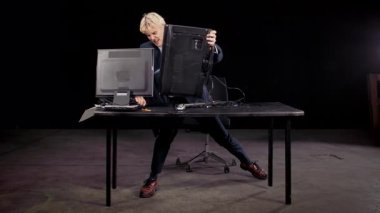 Hüsrana uğramış bir ofis çalışanı zorla bir bilgisayar monitörünü diğerine kırıyor ve ikisine de zarar veriyor. Bir ofis ortamında ağır çekimde yakalanan bu klip, işyerindeki stres, öfke ve teknik hayal kırıklığını temsil ediyor..