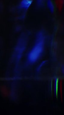 Dynamic colorful prism effects in a dark scene, featuring vibrant light refractions and abstract motion