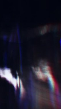 Dynamic light reflections move through textured glass, creating a mesmerizing display of colorful patterns and abstract effects