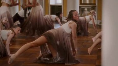 A vibrant youth dance ensemble performs synchronized choreography with precision and flair inside an elegant ballroom