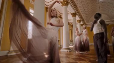 A group of contemporary dancers gracefully perform dynamic movements in an elegant classical venue, blending modern artistry with timeless sophistication
