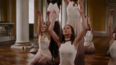 A group of young performers presents an artistic modern dance display, set against the timeless backdrop of a classical hall