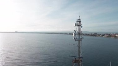 A working modern marine radar station located in a sea small concrete port in the calm blue deep Black Sea, near the ancient Bulgarian resort town of Pomorie with a embankment. UHD 4K video realtime
