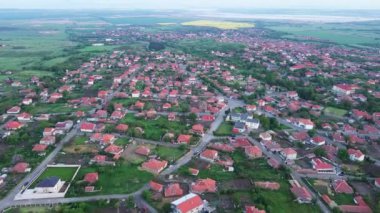 Ancient calm resort town Burgas with modern comfortable hotels and inns and small houses, turns green from spring vegetation in parks against backdrop of sky with white clouds. UHD 4K video realtime