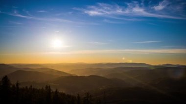 The bright scorching evening sun spread its sunset rays over the mountain valley of the Rhodope Mountains, which took refuge in the shadow of the lowlands. UHD 4K video timelaps
