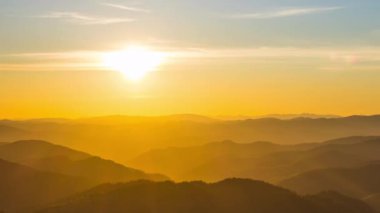 The bright scorching evening sun spread its sunset rays over the mountain valley of the Rhodope Mountains, which took refuge in the shadow of the lowlands. UHD 4K video timelaps