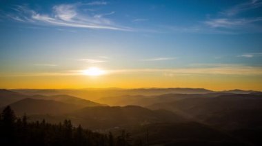 The bright scorching evening sun spread its sunset rays over the mountain valley of the Rhodope Mountains, which took refuge in the shadow of the lowlands. UHD 8K video timelaps