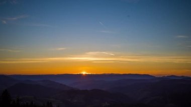 The bright scorching evening sun spread its sunset rays over the mountain valley of the Rhodope Mountains, which took refuge in the shadow of the lowlands. UHD 8K video timelaps