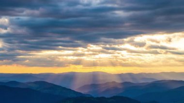 Cloudy weather over low hills covered with spruce evergreen forests in Rhodope Mountains against backdrop of sunset sky, and mystical thick white fog between mountain ranges. UHD 4K video timelaps
