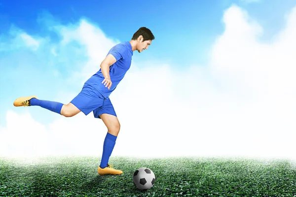 Asijský Fotbalista Muž Modrém Dresu Kopání Míč Fotbalovém Hřišti — Stock fotografie
