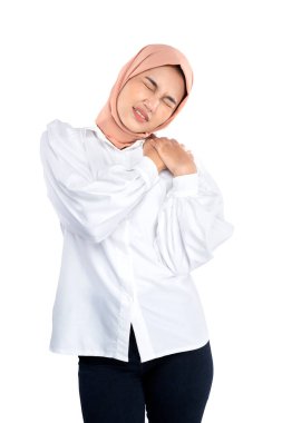 Asian Muslim woman in a head scarf feeling back pain isolated over white background