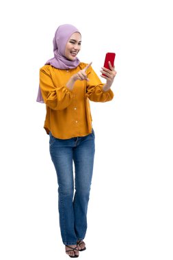 Asian Muslim woman in a headscarf using a mobile phone isolated over white background