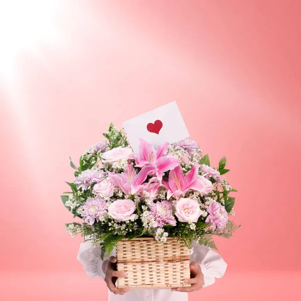 Woman holding a flower bucket with a colored background. Valentines day