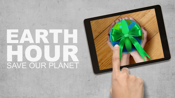 Human hand holding the earth. Earth Hour Concept