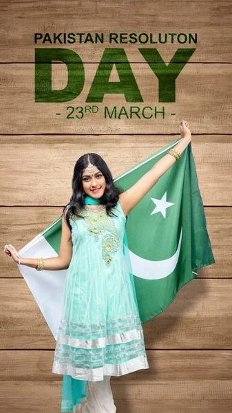 Asian woman holding Pakistan flag. Pakistan Resolution Day