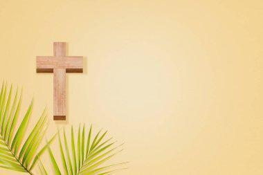 Cross and palm leaf on a colored background. Easter Concept
