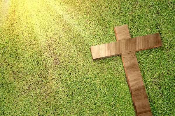 Cross on green grass. Easter Concept