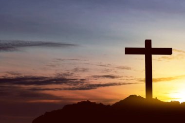 Christian Cross on the hill with sunset sky background