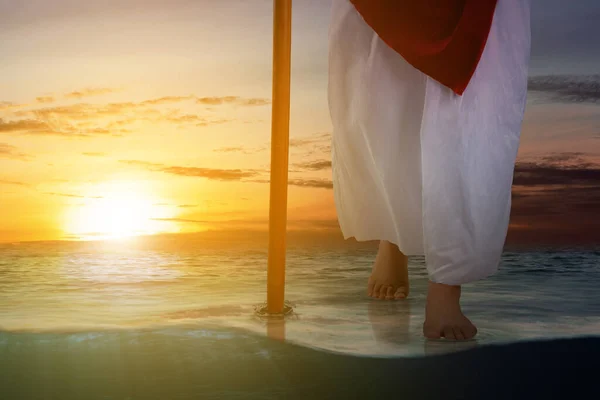 Jesus Christ walking with a stick on the water with dramatic background
