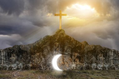 Christian Cross on the rock hill with dramatic sky background